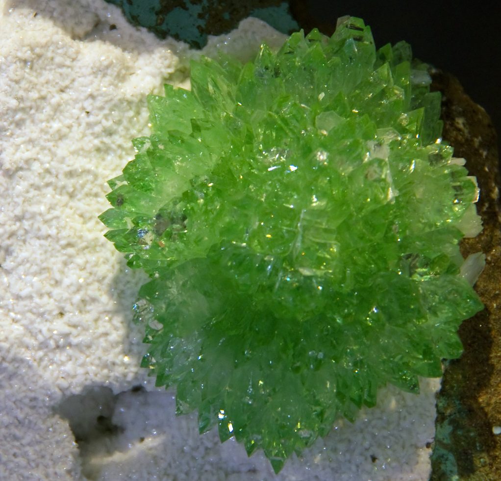 Green apophyllite crystal cluster showing pyramidal crystals with brilliant vitreous luster on matrix