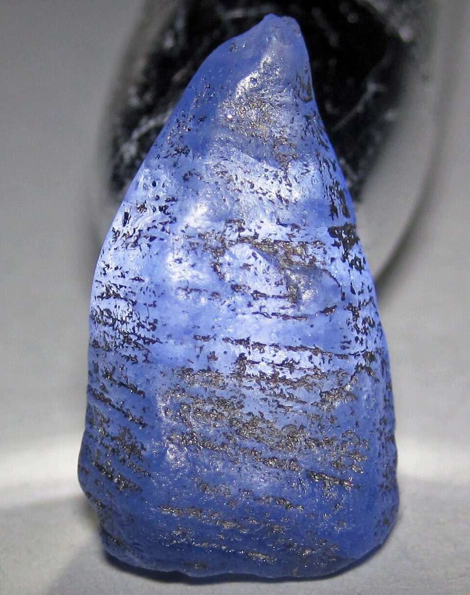 Faceted Ceylon sapphire showing classic cornflower blue color from Sri Lanka on white background