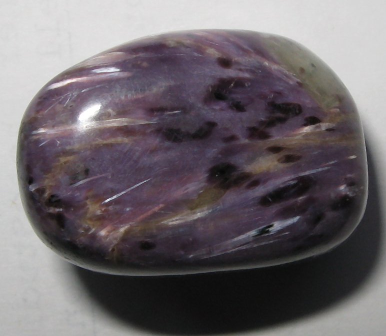 Charoite specimen showing swirling purple-violet-lavender patterns characteristic of this rare Siberian stone