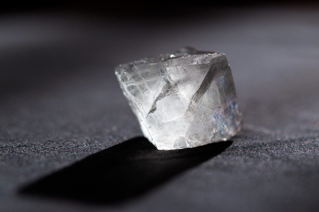 Transparent clear fluorite octahedron showing perfect natural cleavage faces