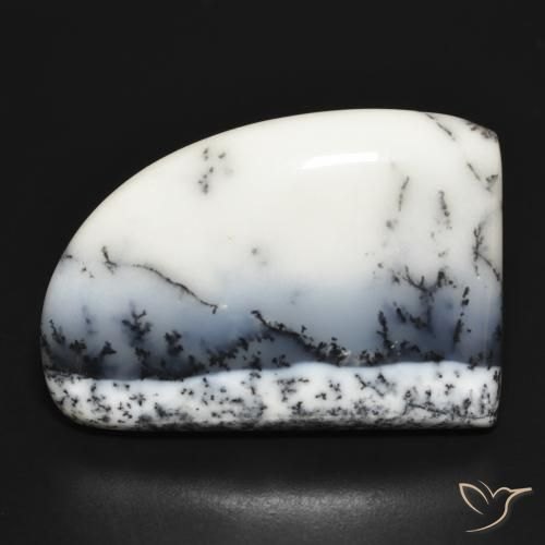 Polished dendritic agate cabochon with manganese tree-like dendrites in cream chalcedony on neutral background