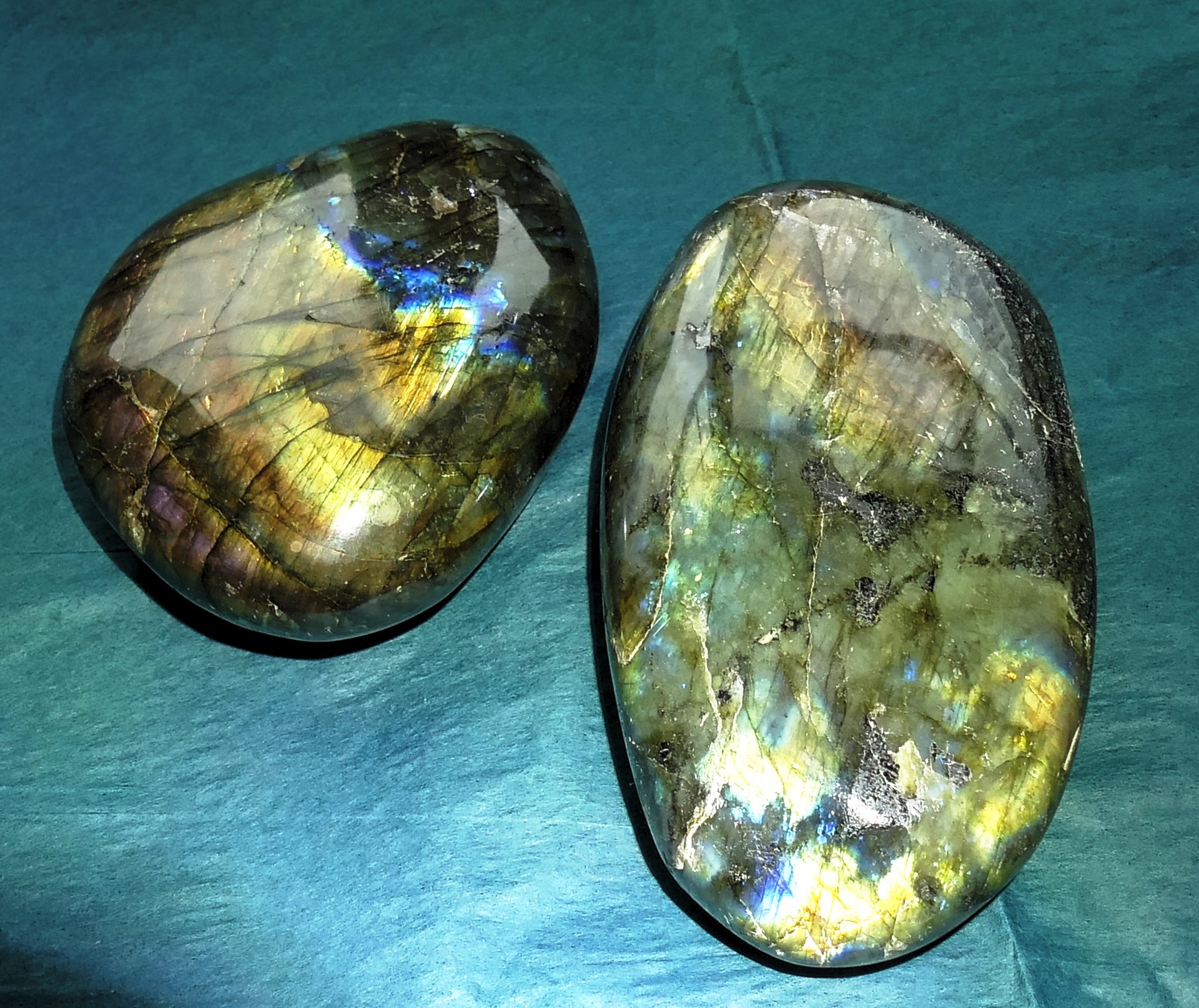 Finnish spectrolite cabochon showing full spectrum labradorescence with red, orange, gold, green, blue, and violet flash