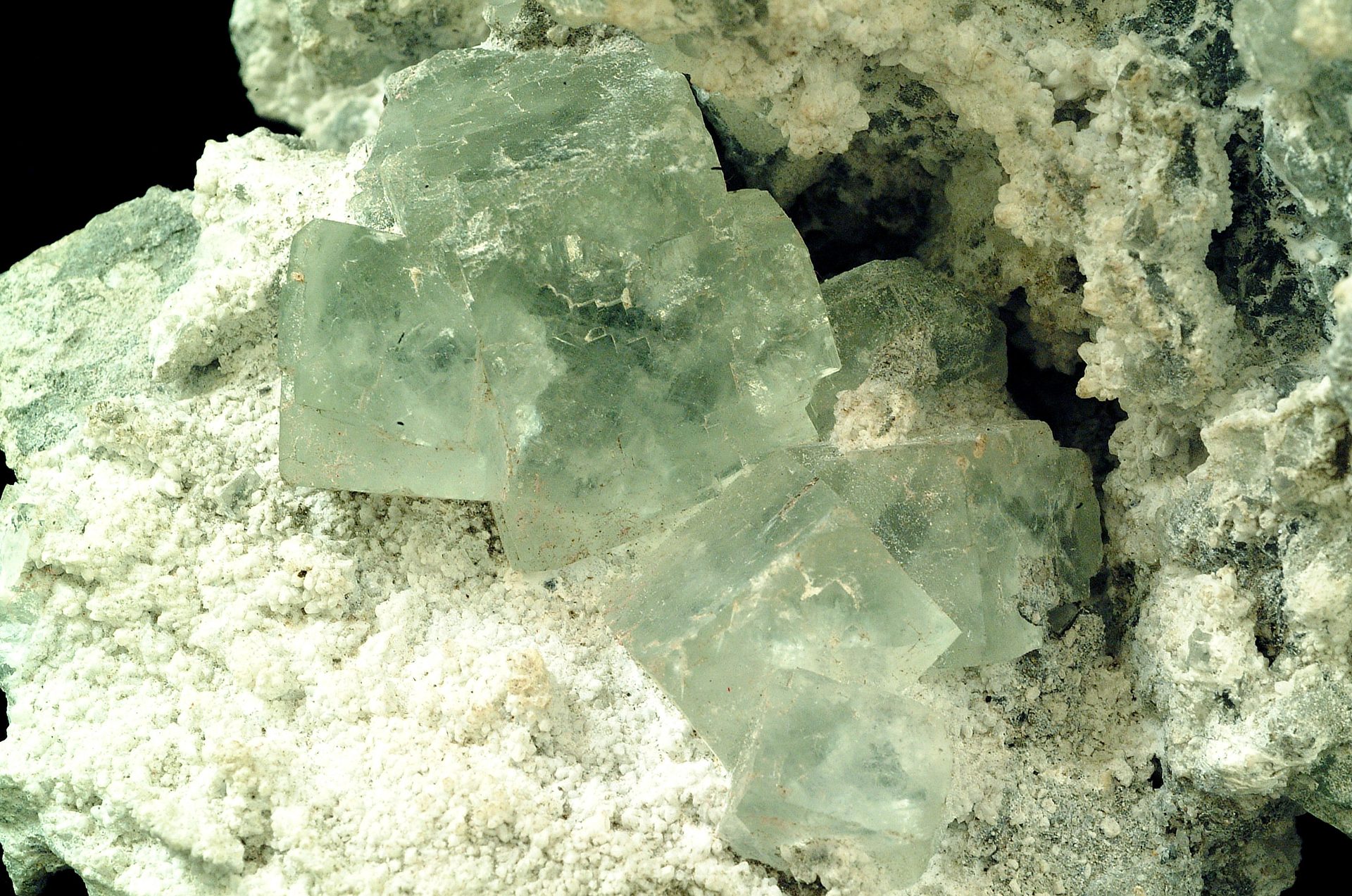 Green fluorite cube showing natural cubic crystal form or polished block with deep green color