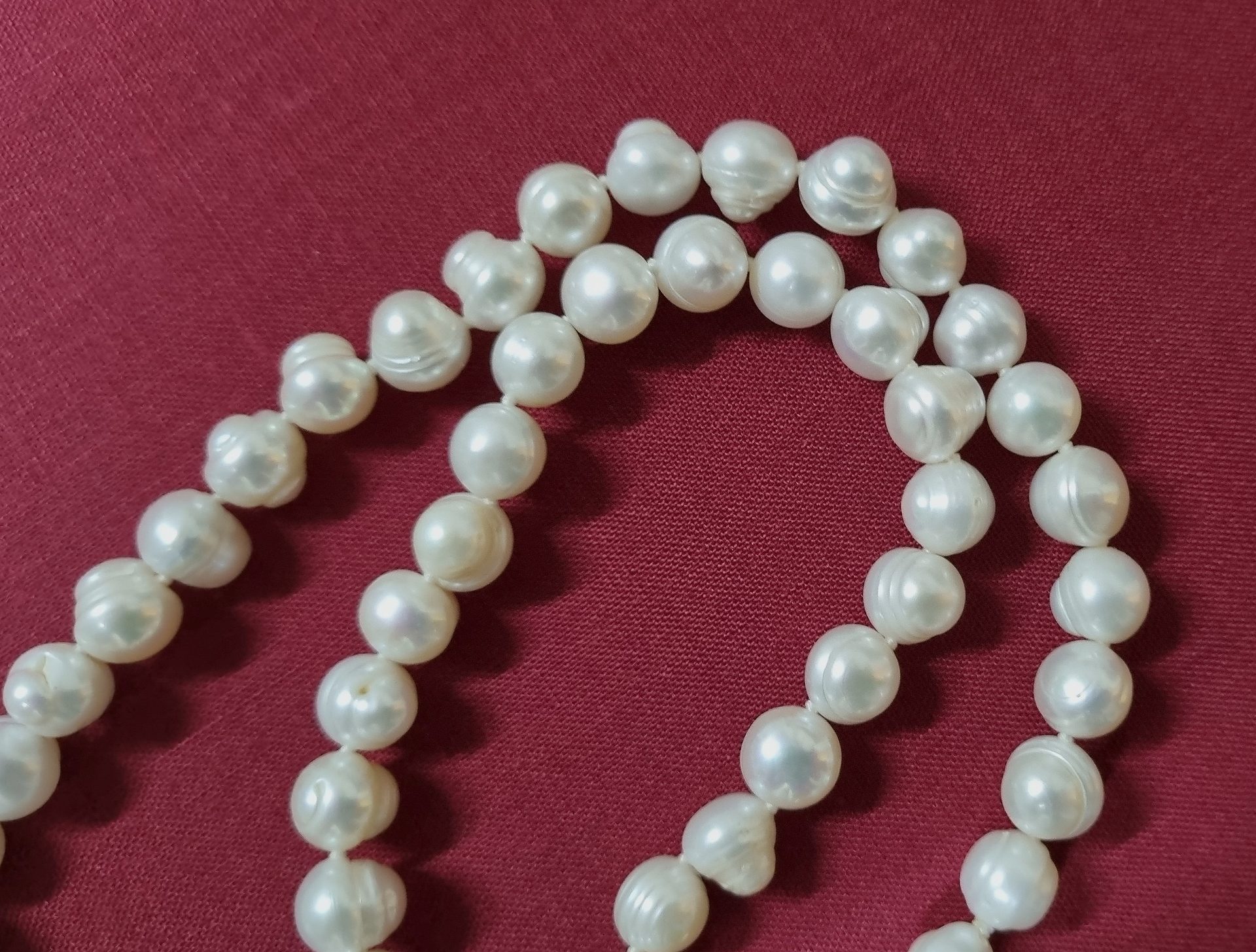 Strand of freshwater pearls showing warm white luster on soft background