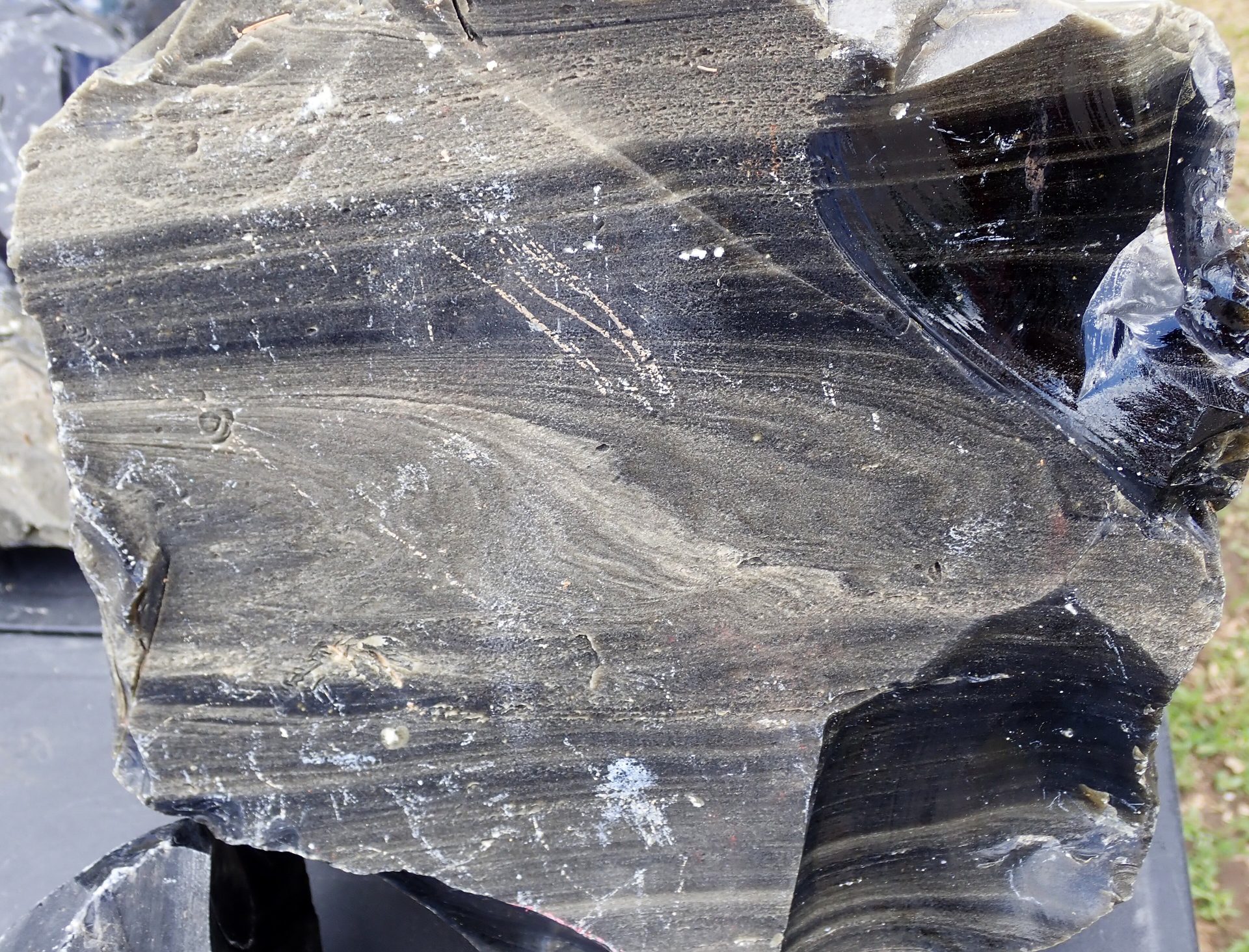 Polished Golden Sheen Obsidian sphere showing floating golden-bronze mirror sheen against jet-black volcanic glass