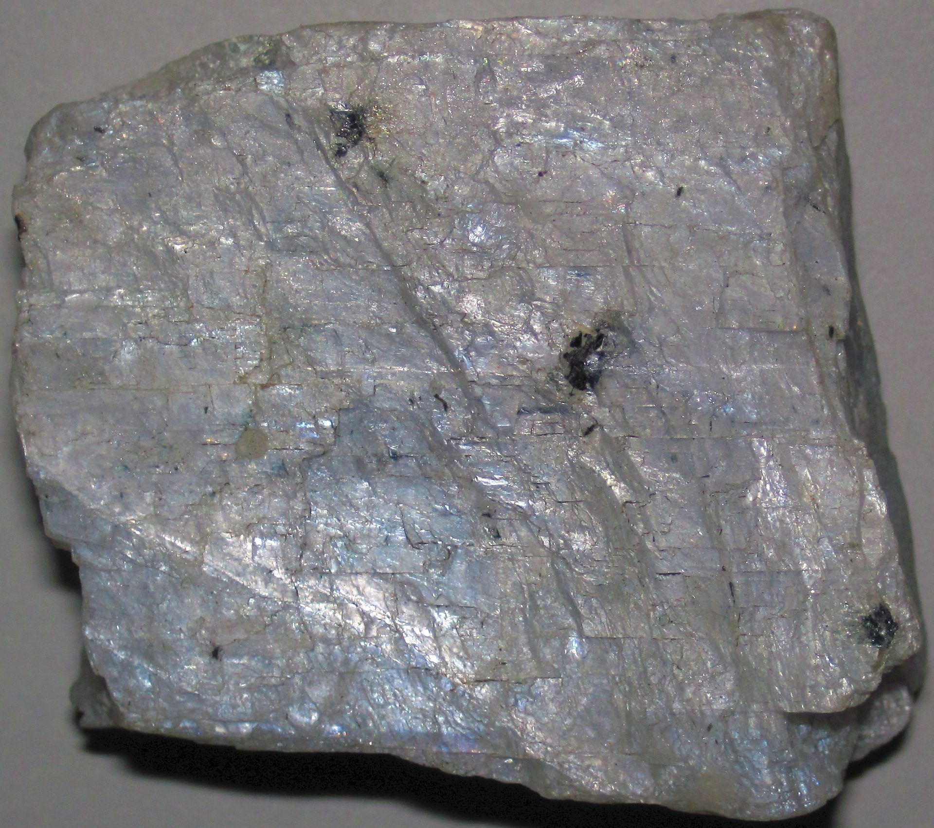 Polished gray moonstone cabochon with silver adularescent sheen