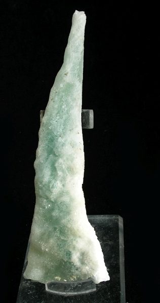 Green calcite polished palm stone showing pale mint to medium green color with natural white zones from Mexico