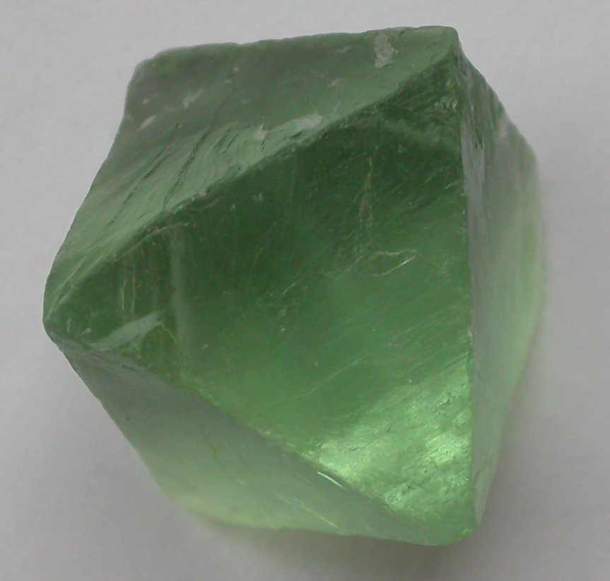 Polished green fluorite point showing translucent mint-green color