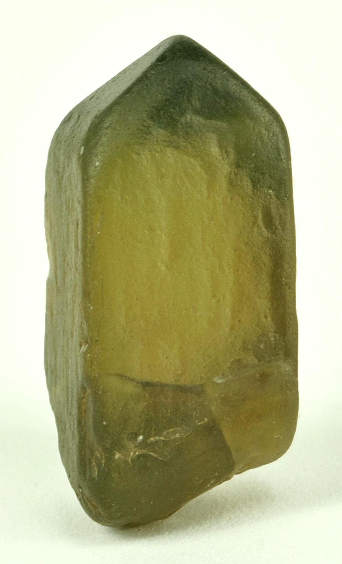 Faceted green zircon gemstone with rich earthy green color and brilliant fire