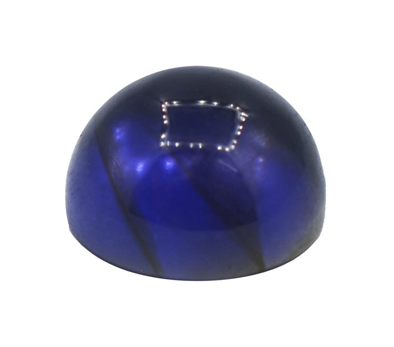 Oval cut iolite gemstone showing violet blue color pleochroism on neutral background