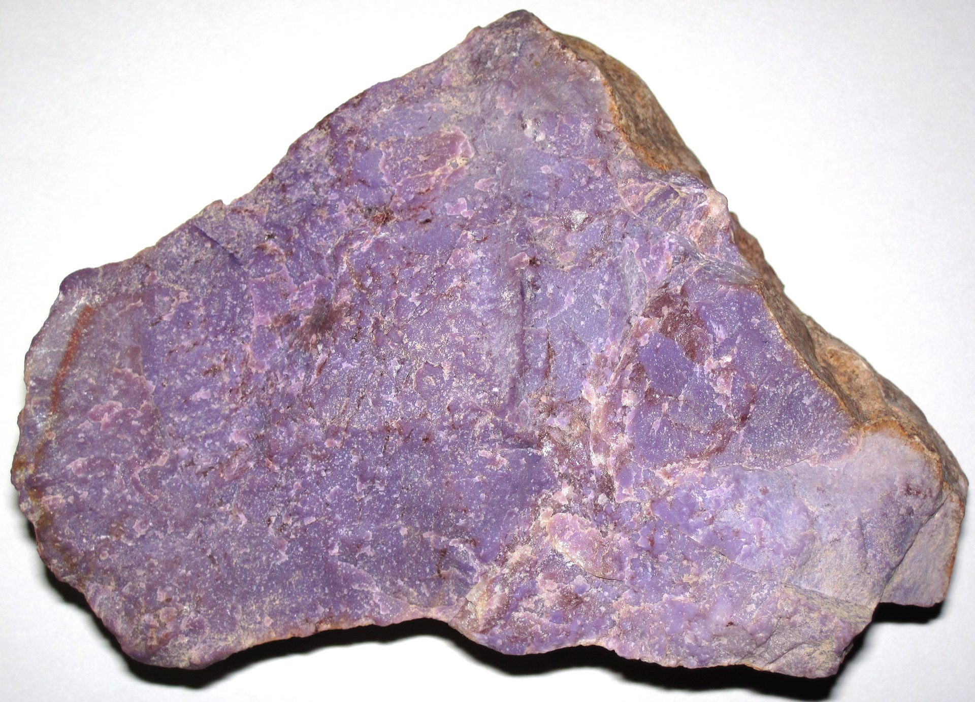 Lavender Jadeite polished cabochon with soft purple color on neutral background
