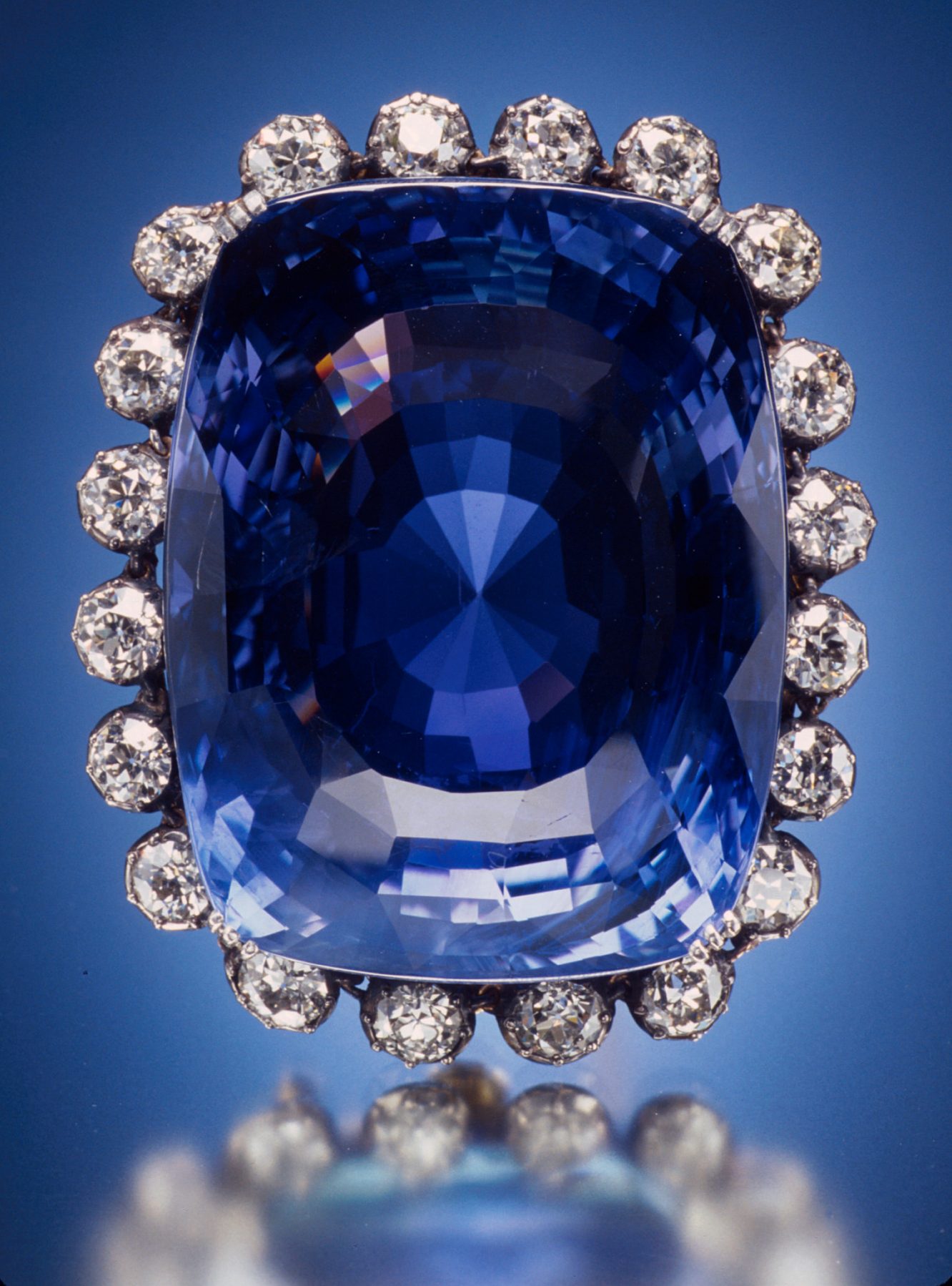 Kashmir sapphire deep velvety blue faceted gemstone on neutral background