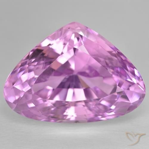 Emerald cut kunzite gemstone showing soft pink to lavender color on neutral background