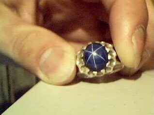 Lab Created blue Sapphire faceted gemstone showing vivid cornflower blue against white background