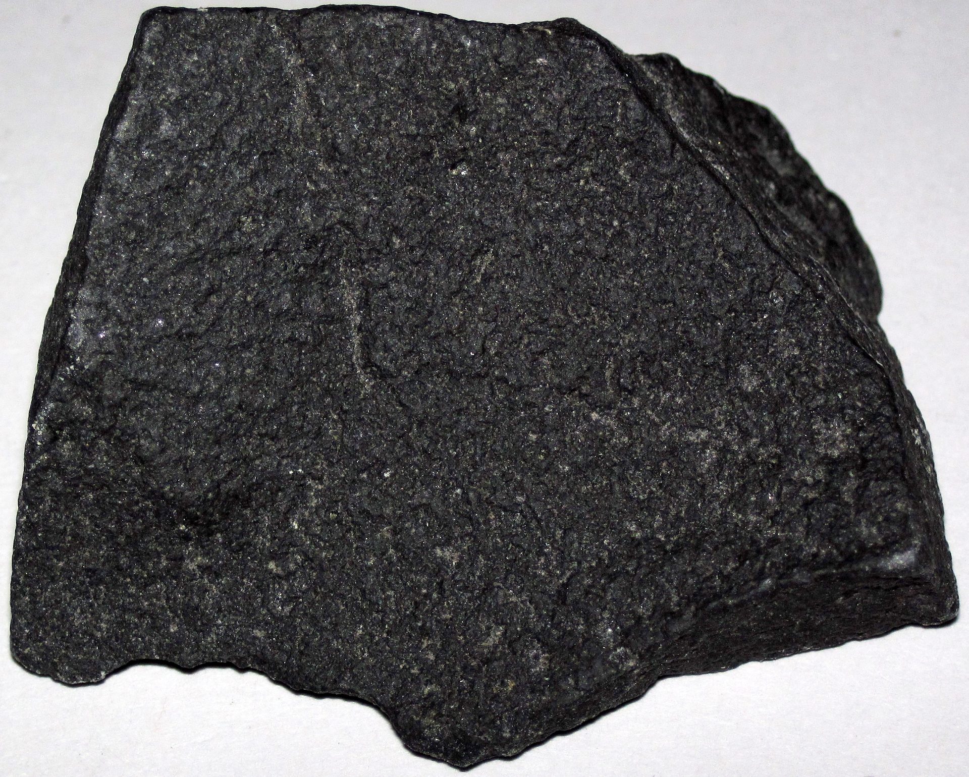 Natural black lava stone beads showing porous volcanic basalt texture on a diffuser bracelet