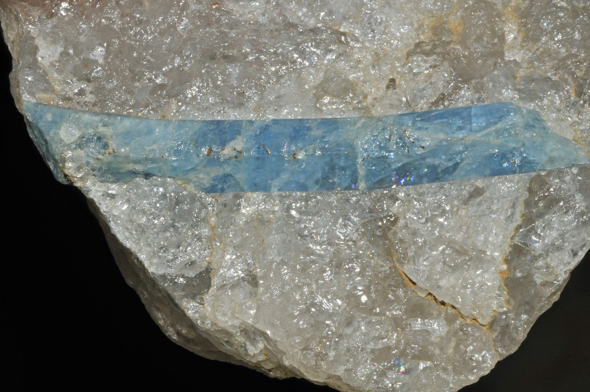 Deep blue maxixe beryl faceted gemstone on neutral background