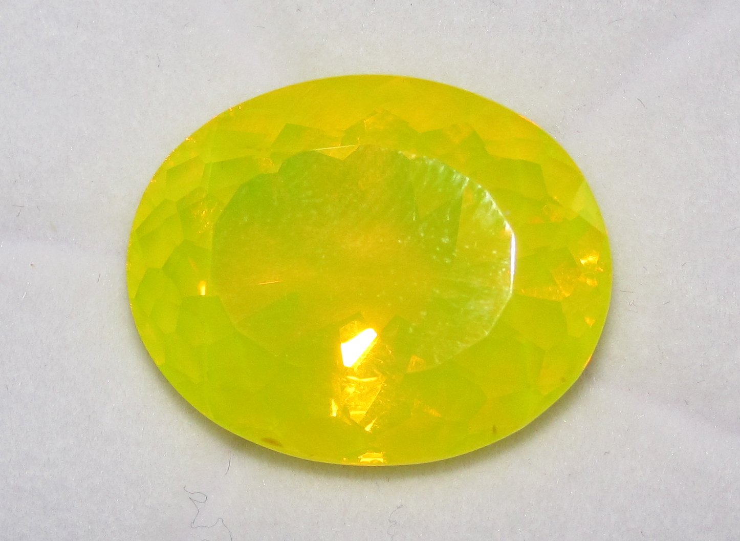 Faceted Mexican fire opal showing vivid orange to red transparent color