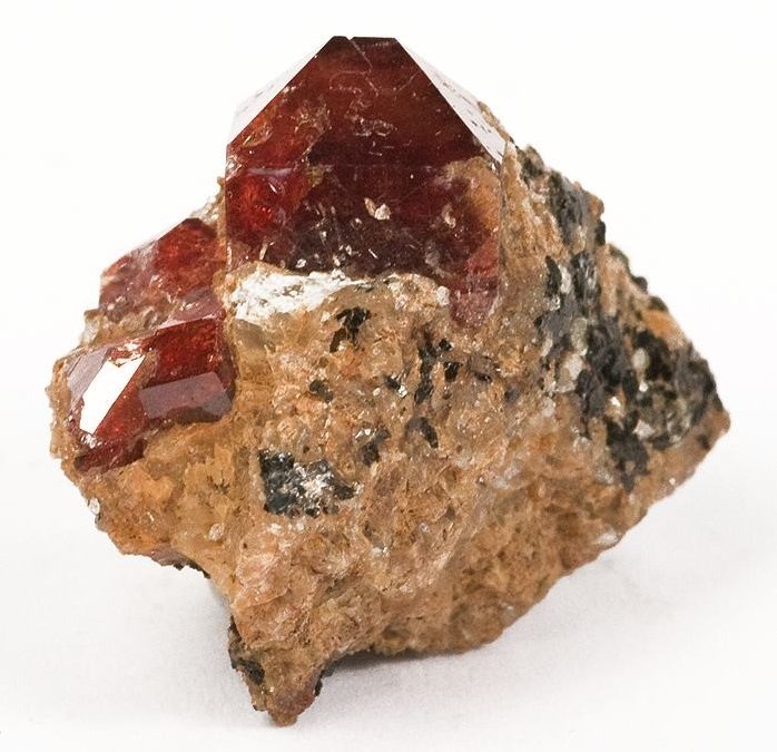 Faceted orange zircon gemstone with warm amber-orange color and brilliant fire