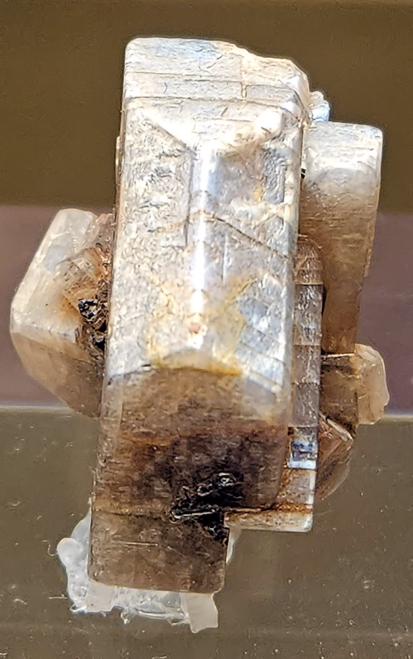 Orthoclase moonstone cabochon showing blue adularescent glow on white feldspar background