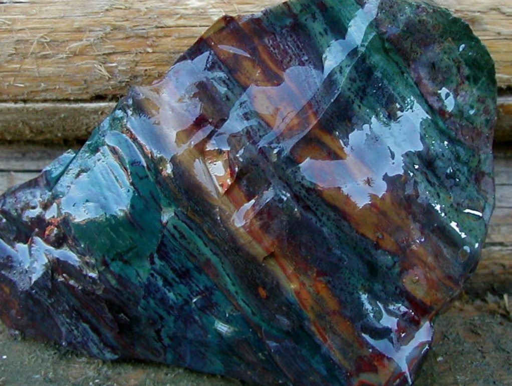 Owyhee jasper cabochon showing purple lavender cream and rust multicolor banding