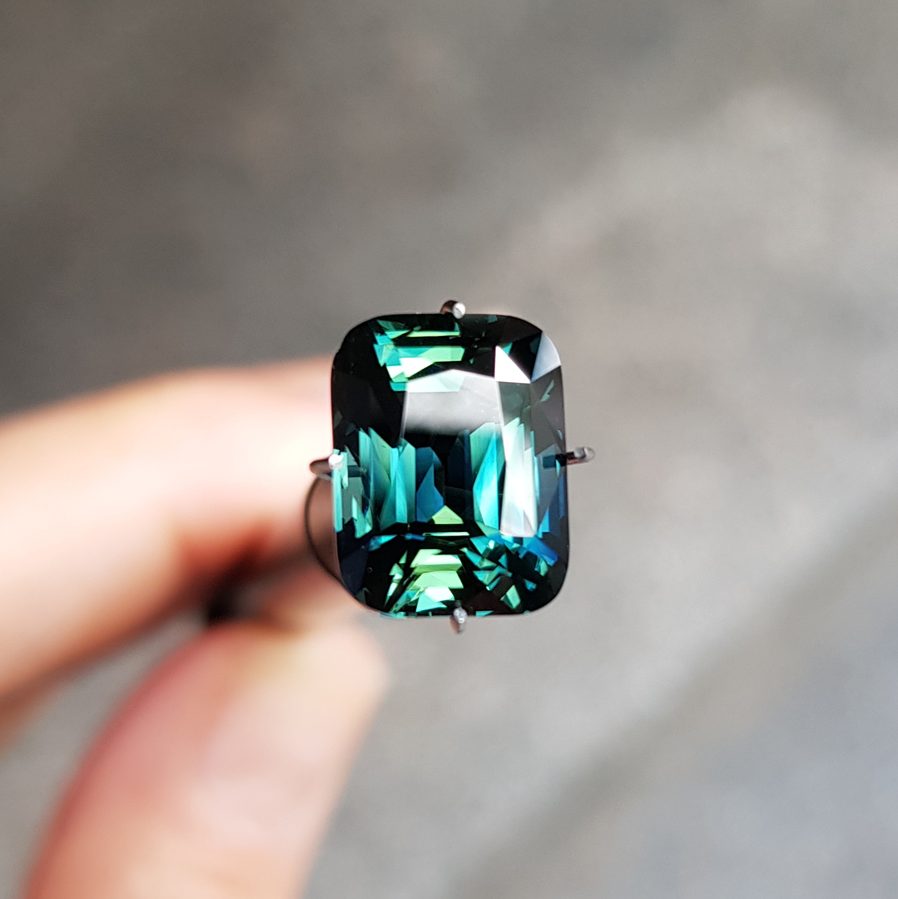 Faceted parti sapphire showing blue-green-yellow color zonation in one gemstone from Australian sapphire fields