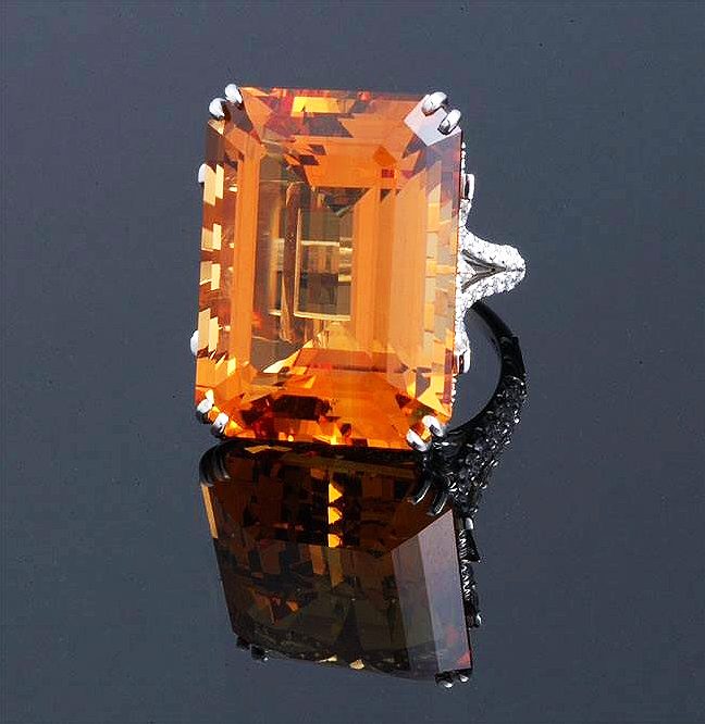 Faceted precious topaz with rich golden-orange imperial color