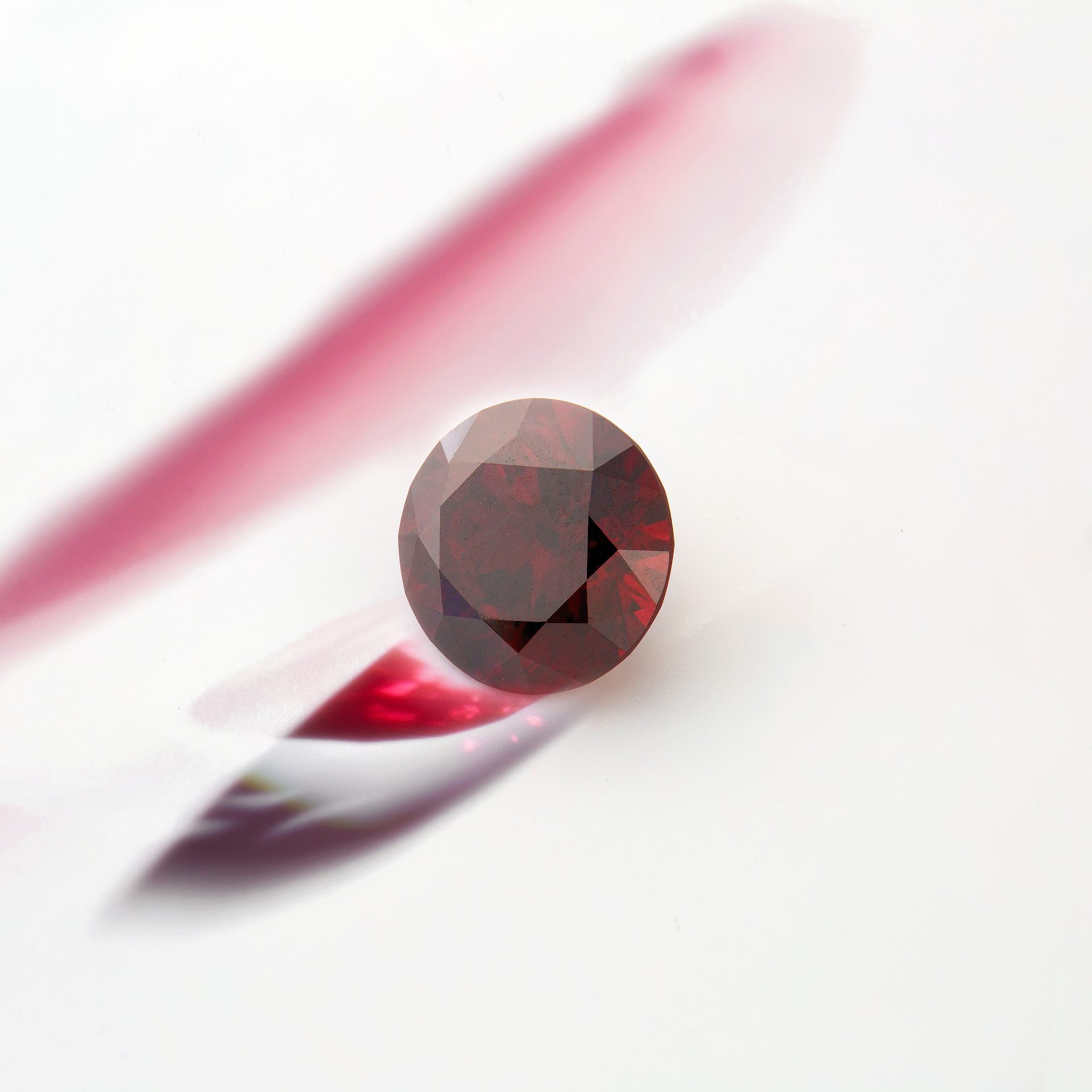 Natural red diamond faceted gemstone showing vivid red color