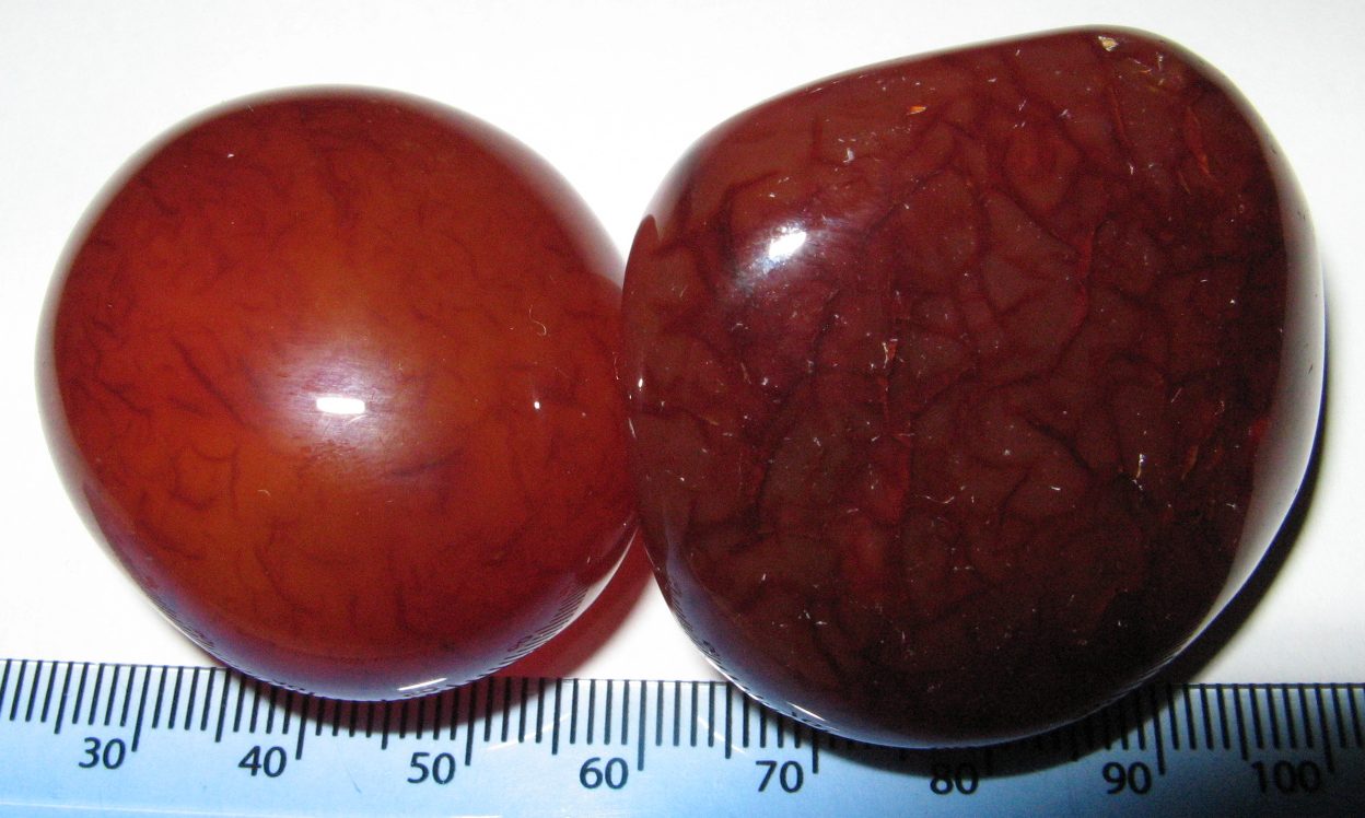 Red jade polished specimen showing warm brick red to deep red color with waxy jade luster