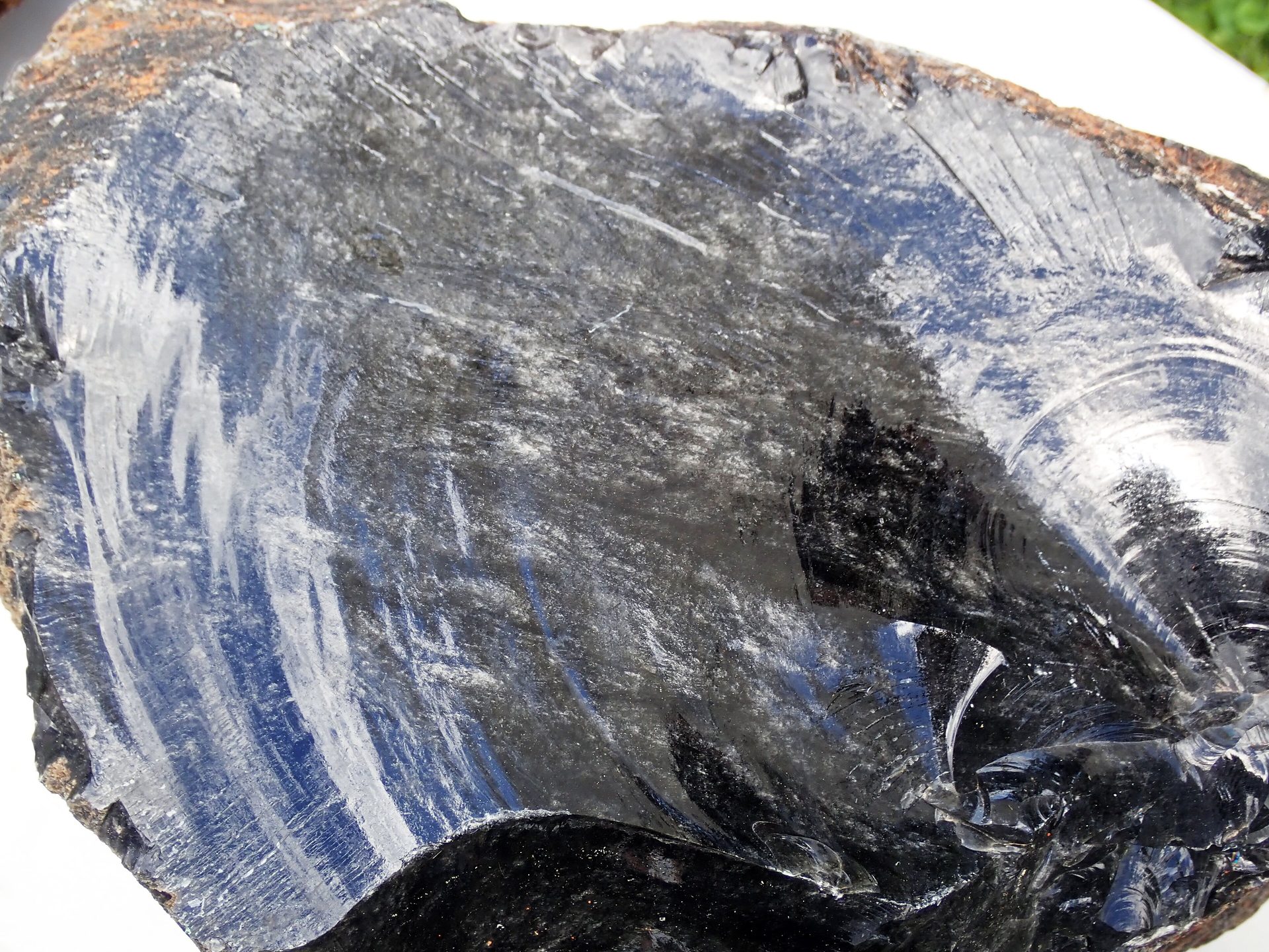 Polished Silver Sheen Obsidian sphere showing floating silver metallic sheen against jet-black volcanic glass