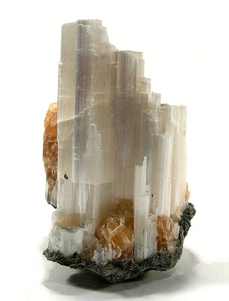 Ulexite slab showing fiber optic image transmission effect against white silky fibrous mineral