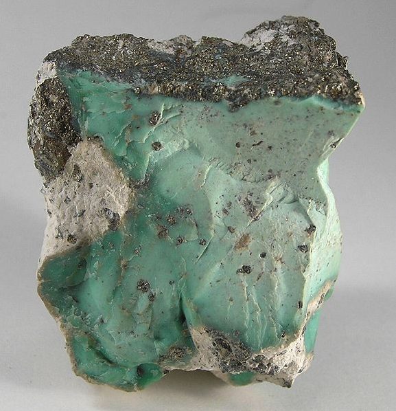 Variscite cabochon showing apple-green color with natural matrix veining
