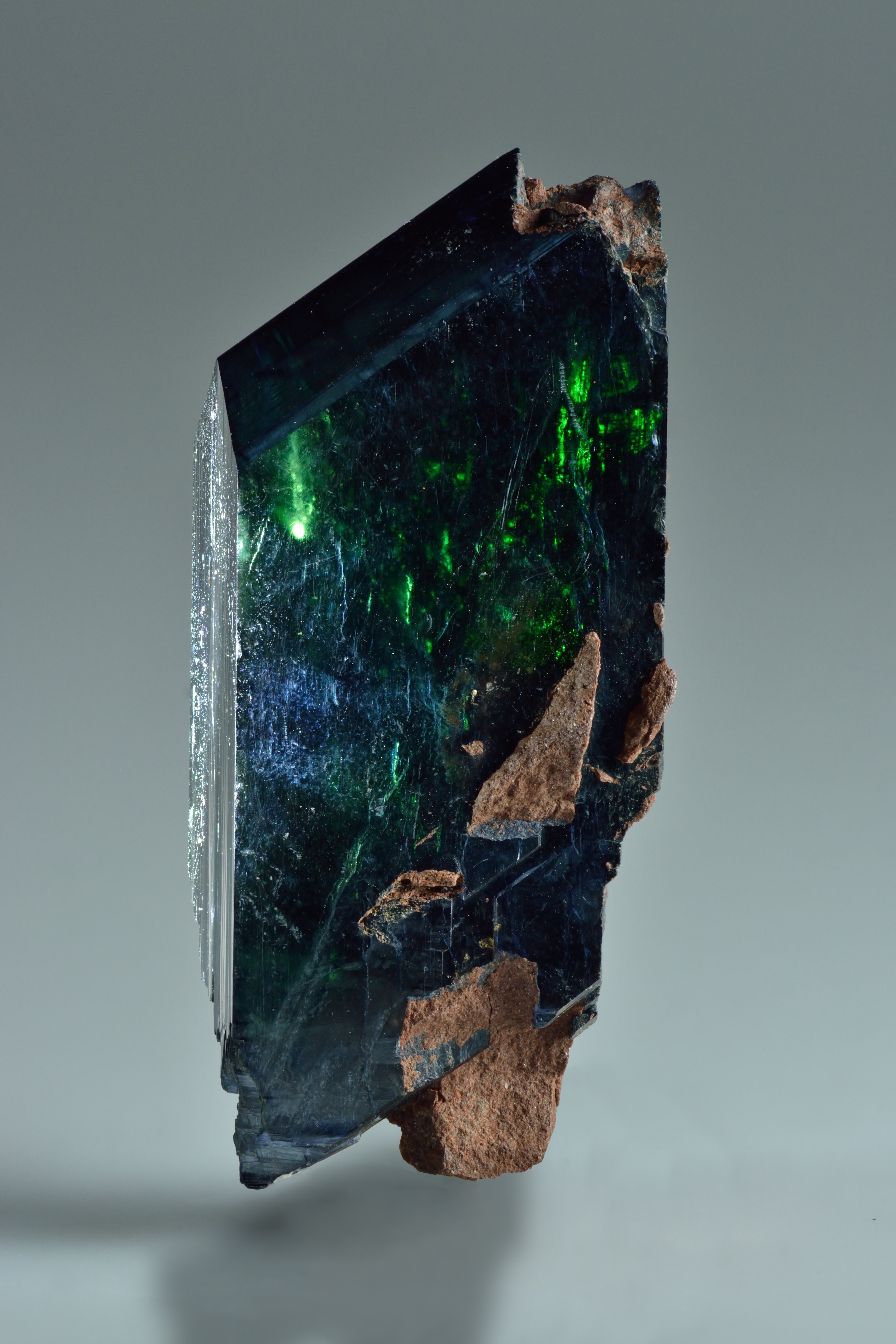 Vivianite crystal cluster showing deep blue prismatic crystals on neutral background